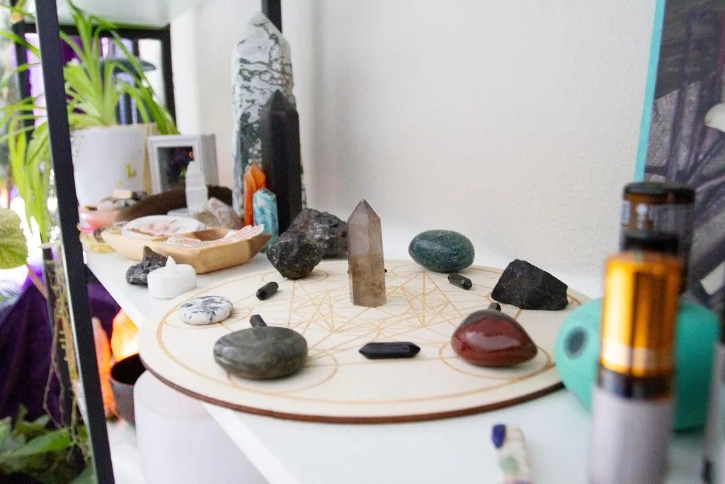Crystal grid arranged on a flower-of-life board at Luna Alchemy
